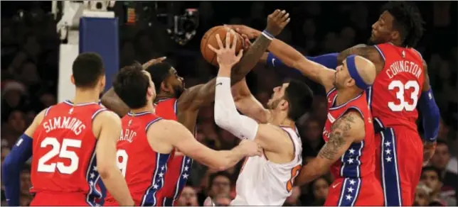  ?? SETH WENIG — THE ASSOCIATED PRESS ?? Sixers defenders swarm over the Knicks’ Enes Kanter, center, during the second half Monday in New York. The 76ers defeated the Knicks 105-98.