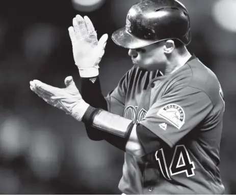  ??  ?? Rockies catcher Tony Wolters shows his excitement Monday night at Coors Field after hitting an RBI single off Washington Nationals relief pitcher Blake Treinen in the eighth inning. Wolters went 3-for-4 at the plate as Colorado won 8-4. David...