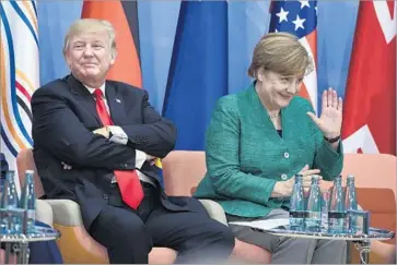  ?? Patrik Stollarz Pool Photo ?? PRESIDENT TRUMP and Chancellor Angela Merkel attend a discussion at the G-20 summit in Hamburg. Merkel’s relationsh­ip with Trump buckled this year when he threatened to impose tariffs on German imports.