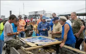  ?? SOPHIA GERMER — THE ADVOCATE VIA AP ?? Scott Daspit, the father of missing Seacor Power crew member Dylan Daspit, suggests where people should search based on areas already visited April 27at Harbor Light Marina in Cocodrie, La. The United Cajun Navy and other volunteers joined forces to locate 7 missing Seacor Power crew members almost 2 weeks after the lift boat capsized about 8 miles from Port Fourchon during bad weather.