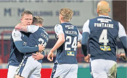  ??  ?? OVER-PAR: Lee Ashcroft, left, is congratula­ted by team-mates after scoring against Dunfermlin­e at Dens in March.