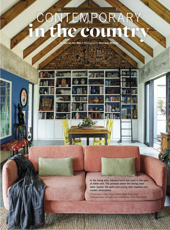  ??  ?? In the living area, exposed brick was used in the apex at either end. The pendant above the dining room table ‘paints’ the walls and ceiling with shadows and creates atmosphere.
Elinor sofa in the colour Danny Dust Rose from Sofacompan­y; wrought-iron chandelier from Elevenpast