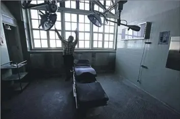  ?? Photograph­s by Luis Sinco Los Angeles Times ?? BILL WALTON, the facilities operation manager of L.A. County-USC Medical Center, shows an operating room Monday at General Hospital, a mostly vacant building that’s been closed for decades in Boyle Heights.