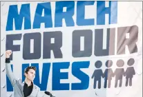  ??  ?? David Hogg, a survivor of the mass shooting at Marjory Stoneman Douglas High School in Parkland, Fla., raises his fist after speaking during the “March for Our Lives” rally in support of gun control in Washington, Saturday.