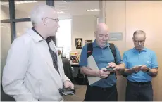  ?? NICK PROCAYLO ?? Retired Vancouver Sun sports reporters Brad Ziemer, Gary Kingston and Elliott Pap compare notes during a staff sendoff.