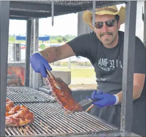  ?? NIKKI SULLIVAN/CAPE BRETON POST ?? Peter Allen, a ribber with Camp 31 from Alabama, shows off a piece of rib during the last day of Sydney Ribfest on Sunday. The three-day event drew an estimated 30,000 visitors.