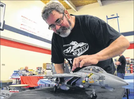  ?? FRAM DINSHAW/ TRURO NEWS ?? It took months for Mitchell Lepine to build and paint his scale model of a U.S. Navy F-14 Tomcat, the iconic  ghter Top Gun movie fame. Given its own unique paintwork, the plastic model is delicate and must be handled with care. of