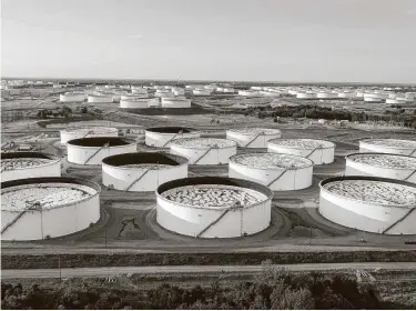  ?? Johannes Bisele / AFP via Getty Images ?? Crude oil storage is full in Cushing, Okla. For the first time in 15 weeks, the amount of available crude oil in the U.S. declined.