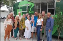  ?? ?? Marcelle Epley, left, Vern Schooley, Suzanne Nosworthy, Tom Burns, CSULB President Jane and Collie Conoley, Cheri Bazely, Host Gary DeLong holding his granddaugh­ter Charlotte, Sofia and Jim Riley and Dr. Grant Uba at the Beyond Food Truck