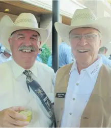  ??  ?? Pictured at Field Law’s Stampede party are Mike O’Connor, left, and Michael Casey, Q.C., Calgary Airport Authority board chair.
