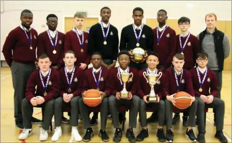  ??  ?? The winning St Oliver’s team reassemble in the school gym with their medals and trophies.