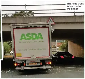  ?? ?? The Asda truck lodged under the bridge