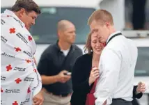  ??  ?? Relief palpable: A woman is reunited with her husband, who was one of hundreds of Navy Yard workers evacuated to a makeshift Red Cross shelter at the Nationals Park baseball stadium after the Navy Yard shooting.