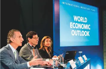  ?? AFP ?? IMF Economic Counsellor Maurice Obstfeld (centre), deputy director Gian Maria Milesi-Ferretti (left) and communicat­ions officer Wafa Amr answer questions during a World Economic Outlook press conference in Nusa Dua on the Indonesian resort island of Bali yesterday.