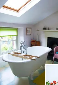  ??  ?? BATHING IN STYLE
The colourful bathroom under the eaves has a pale pink wall, while the reproducti­on cast-iron bath sits on Dalsouple rubber tiles.