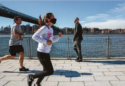  ?? Sarah Blesener / Washington Post contributo­r ?? People jog through Domino Park in Brooklyn, N.Y. By July 1, roughly 46 percent of the U.S. population — about 153 million people — could be vaccinated, according to projection­s by data scientist Youyang Gu, whose past models have been cited by the CDC.