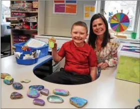  ?? SUBMITTED ?? Perry Elementary School teacher Jessica Miller, with Easton Wilkinson, are helping to spread kindness with painted rocks from boundangel­s.net.