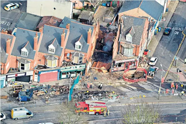  ??  ?? Little remains of the convenienc­e store and accommodat­ion above it after an explosion in a parade of shops killed at least five people in Leicester on Sunday night. Neighbours pulled some of the injured from the wreckage