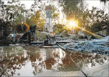  ?? Katie Falkenberg Los Angeles Times ?? RESIDENTS who lost houses in f lat areas of Point Dume may have an easier time rebuilding than those who lived on hillsides. Above, the sun sets on a destroyed home on Wandermere Road in the Point Dume area.