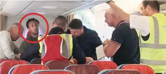  ??  ?? Escorted off: Yaqub Ahmed, circled, during the confrontat­ion on the Turkish Airlines flight at Heathrow last Tuesday