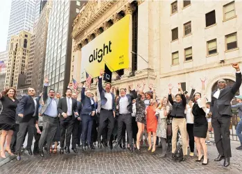  ?? ?? ALIGHT COLLEAGUES CELEBRATE THE COMPANY’S FIRST YEAR ON THE NEW YORK STOCK EXCHANGE WITH CEO STEPHAN SCHOLL AND CHRO MICHAEL ROGERS.