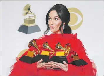  ?? Marcus Yam Los Angeles Times ?? KACEY MUSGRAVES holds her four awards — including for album of the year for “Golden Hour” — at the 61st Grammy Awards. Last year, the show was roundly criticized for leaving women out of top categories.