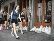  ?? Scott Olson / Getty Images ?? Sandbags are lined up along a restaurant in New Orleans on Friday in anticipati­on of Tropical Storm Barry dumping more than a foot of rain in the state.