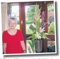  ??  ?? ●●Elizabeth Milne enjoying the St Aidan’s flower display