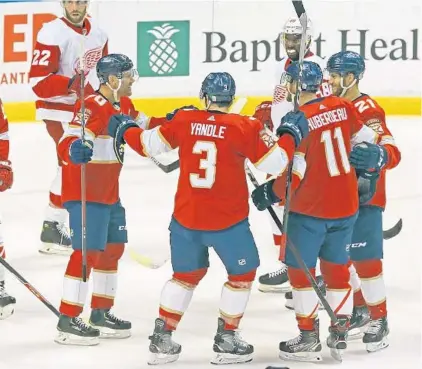  ?? CHARLES TRAINOR JR./MIAMI HERALD ?? The Panthers celebrate after a goal by Alex Wennberg against Detroit on Tuesday at BB&T Center in Sunrise.