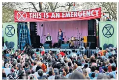  ??  ?? One voice: Greta imagined as an angel, top, and above, addressing climate change protests in London. Below, her mother Malena Ernman, with Greta’s sister Beata