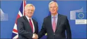  ?? AFP ?? Britain's Brexit Minister David Davis (left) and EU’s Michel Barnier shake hands in Brussels on Monday ahead of talks