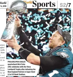  ??  ?? PHILADELPH­IA EAGLES quarterbac­k Nick Foles (#9) celebrates with the Vince Lombardi Trophy after defeating the New England Patriots in Super Bowl LII at US Bank Stadium.