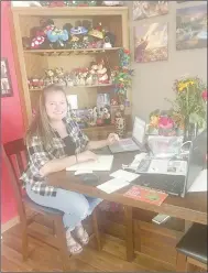  ??  ?? Pineville Elementary School teacher Jessica Pike works from her kitchen table during the covid-19 outbreak, which has caused schools to be closed for the remainder of the school year.