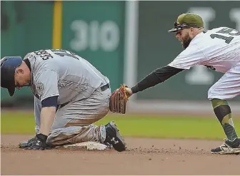  ?? STAFF PHOTO BY NANCY LANE ?? NOT QUITE: Sox second baseman Dustin Pedroia is late with the tag on a double by Seattle’s Kyle Seager in the fourth inning of yesterday’s game at Fenway.