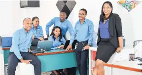  ??  ?? Ryan Sterling, chief executive officer; Coleen Hibbert, IT systems engineer; Omar Henry, first line field engineer; seated at the desk is Yanique Douglas, engagement officer; Matthew Hanson applicatio­n developer; Cameille Sterling, chief operations...