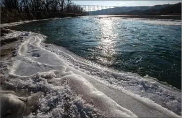  ?? Herald photo by Ian Martens ?? Open water flows past the icy banks of the Oldman River Wednesday in the city’s river valley. @IMartensHe­rald