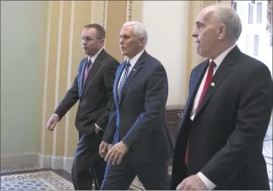  ?? Alex Edelman / Getty Images ?? Vice President Mike Pence, center, and acting White House Chief of Staff Mick Mulvaney, left, depart the U.S. Capitol on Saturday.