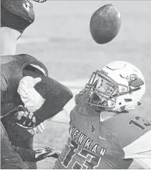  ?? JOHN RENNISON THE HAMILTON SPECTATOR ?? St. Thomas More's Robert Kern strips the ball from Cardinal Newman's Nate Cusimamo after Cusimamo had rushed for a first down. More recovered the ball and also came up some critical intercepti­ons during its 17-7 victory.