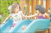  ?? Contribute­d photo ?? Two 4-year-olds play on a slide at the Neighborho­od Preschool on High Street in Middletown.