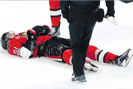  ?? FRED CHARTRAND/THE CANADIAN PRESS ?? Ottawa Senators’ Mark Stone lies injured on the ice after being hit hard by Winnipeg Jets’ Jacob Trouba (not shown) during the third period in Ottawa, Sunday.