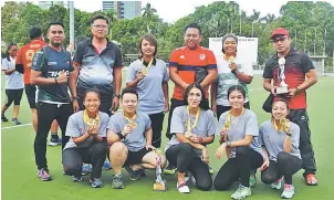  ??  ?? Kuching HC pose with their medals and trophy at the Sarawak Hockey Stadium Sunday.