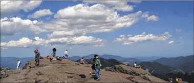  ?? Paul Buckowski / Times Union archive ?? Hikers spend time on the summit of Mount Marcy in Keene in 2002. Mount Marcy is the highest point in New York state, making it a very popular destinatio­n for Adirondack Park hikers.