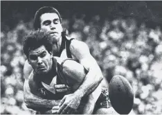  ??  ?? TOUGH STUFF: Greg Phillips tackles Greg Williams in 1987 while playing for Collingwoo­d.