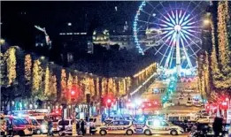 ?? OLIVIER CORSAN/ZUMA PRESS ?? Police secure the Champs-Elysees on Thursday after a gunman shot and killed one police officer and wounded two others. Islamic State claimed responsibi­lity for the attack.