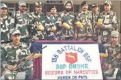  ??  ?? BSF director general of police JS Oberai along with jawans showing seized heroin in Amritsar on Friday,