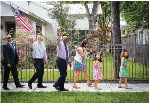  ?? Marie D. De Jesús / Houston Chronicle ?? Mayor Sylvester Turner waves at Houston Heights neighbors as he joins Mitch Blitz, left, his wife, Dawn, and daughters Annie, 5, and Sophie, 8, for a walk on Friday.