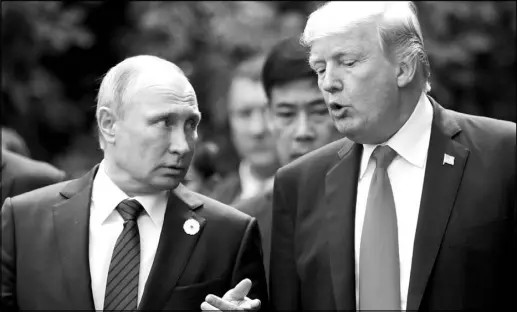  ?? JORGE SILVA / POOL VIA THE NEW YORK TIMES (2017) ?? President Donald Trump and Russian President Vladimir Putin converse in Danang, Vietnam.