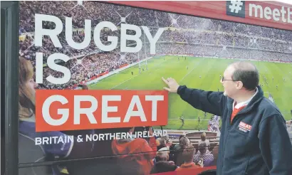  ?? Picture: AFP ?? GREAT PR. Joel Watson, first secretary at the British High Commission, standing alongside a bus in Auckland, set up as a mobile office to help rugby fans visiting New Zealand for the British and Irish Lions tour.