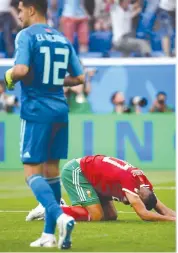  ?? AFP ?? Morocco forward Aziz Bouhaddouz reacts after scoring an own goal in the World Cup Group B match against Iran at the Saint Petersburg Stadium on Friday. —