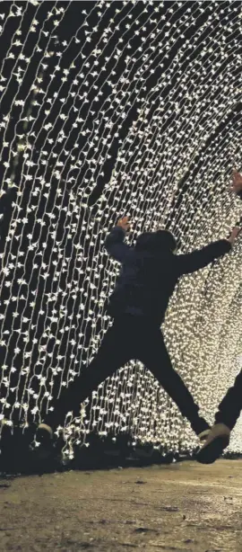  ??  ?? 0 Children jump inside a 70-metre-long 'Cathedral of Light' created